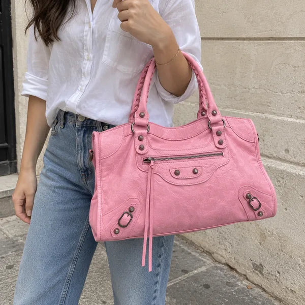 AI-generated image: bag It Girl medium, baby pink, in an everyday setting
