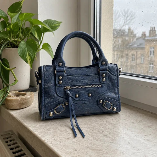 AI-generated image: bag It Girl small, navy blue, in an everyday setting