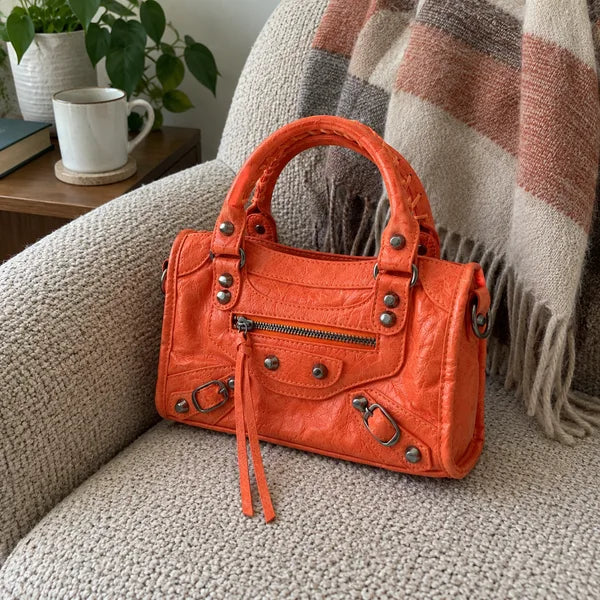 AI-generated image: bag It Girl small, coral, in an everyday setting